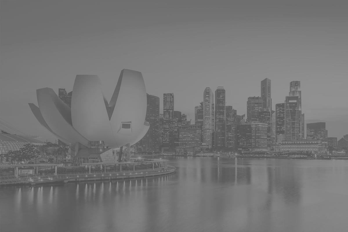 a city skyline with a flower shaped building in the foreground and a body of water in the background .
