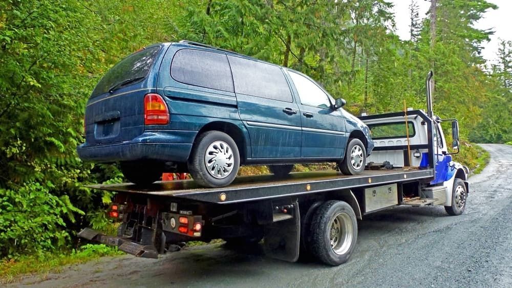 A Blue Van is Sitting on Top of a Tow Truck — Venus Couriers Pty Ltd In Paget, QLD