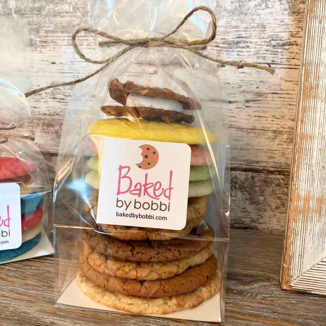 A bag of baked by bobbi cookies stacked on top of each other