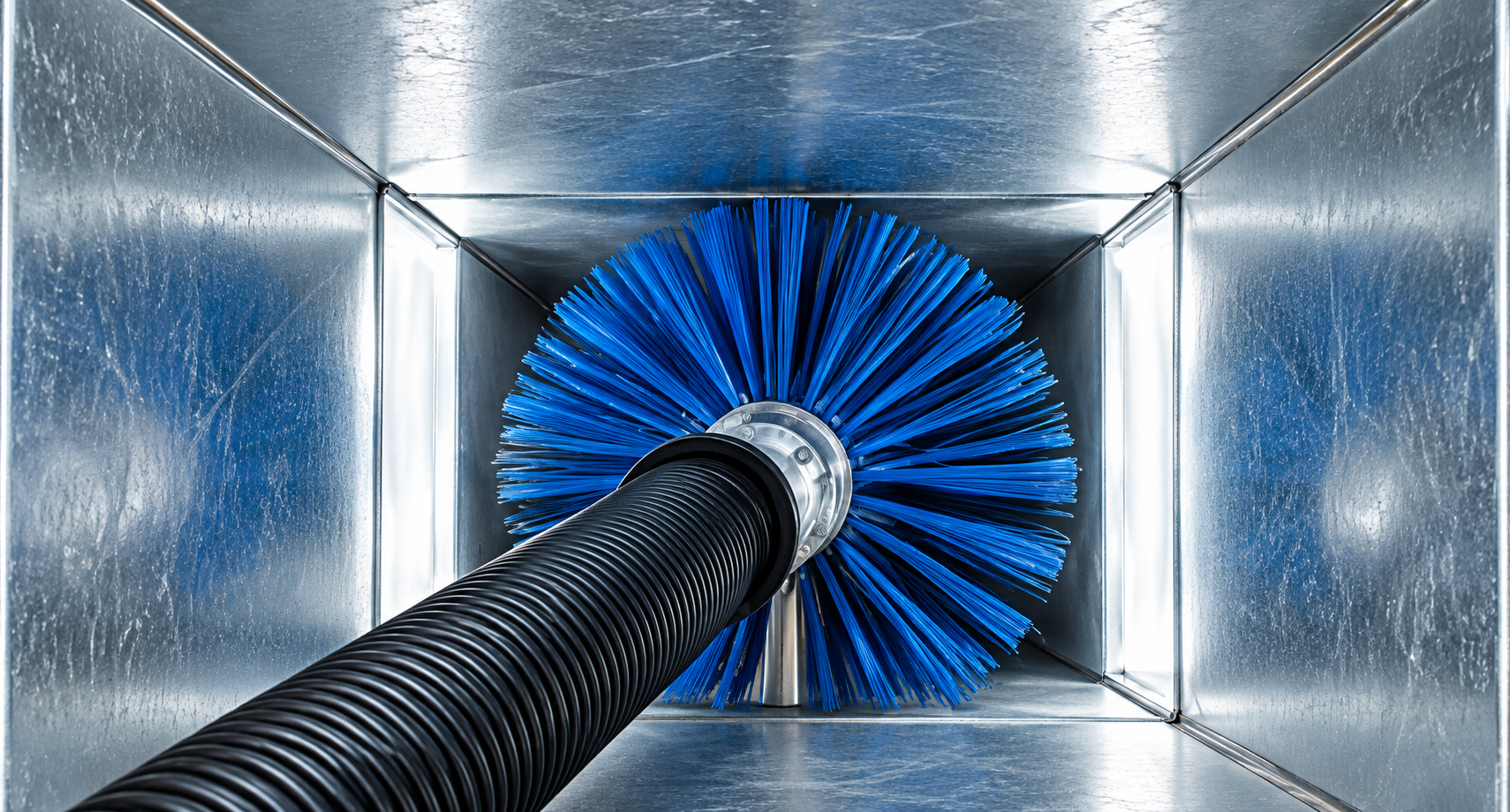 Blue brush inside a metal HVAC duct, cleaning the interior walls