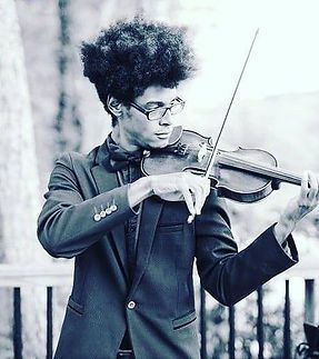 A man in a suit and bow tie is playing a violin. A man in a suit and bow tie is playing a violin.