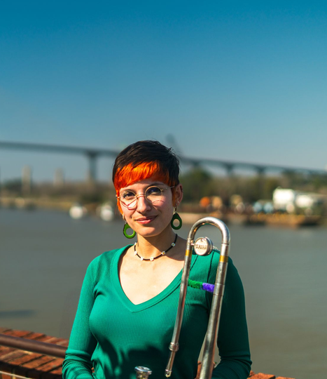 Woman with glasses holding trombone Woman with glasses holding trombone
