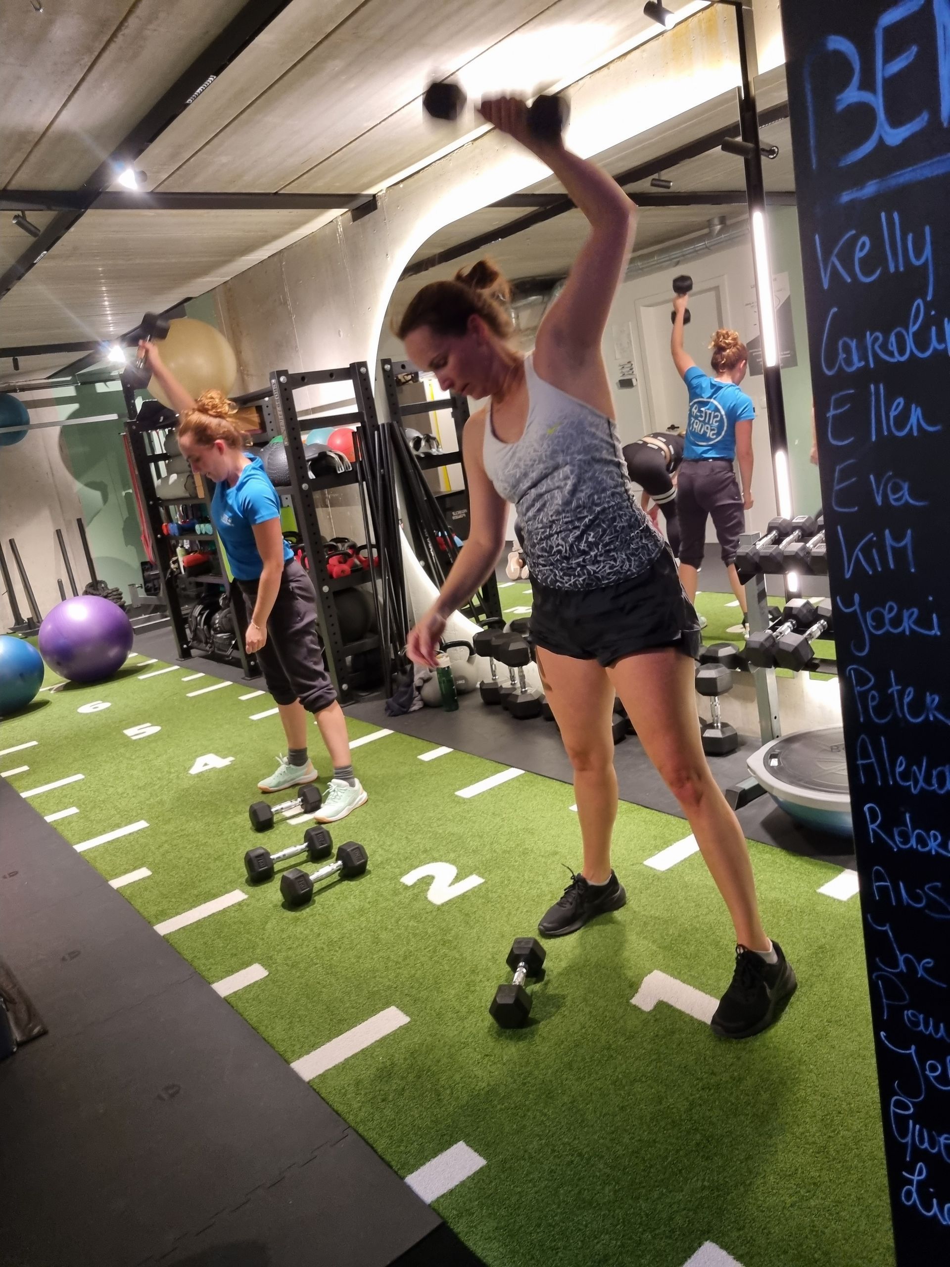 Mensen die in een sportschool met kettlebells trainen