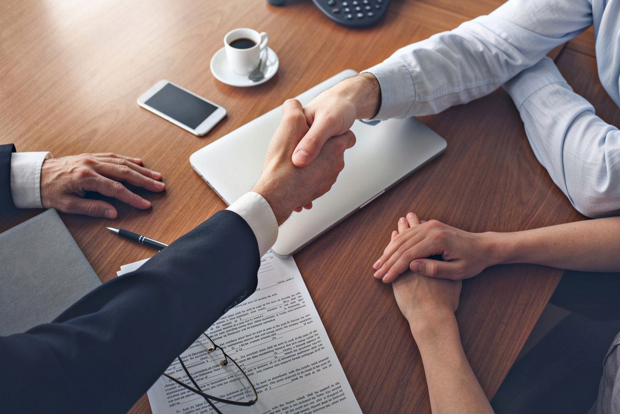 Business People Shaking Hands Over a Table With Documents — MoneySmith Group In Kingscliff, NSW