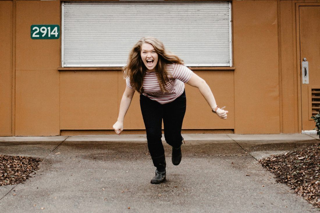 A Happy Woman in Front of a Building — MoneySmith Group In Kingscliff, NSW