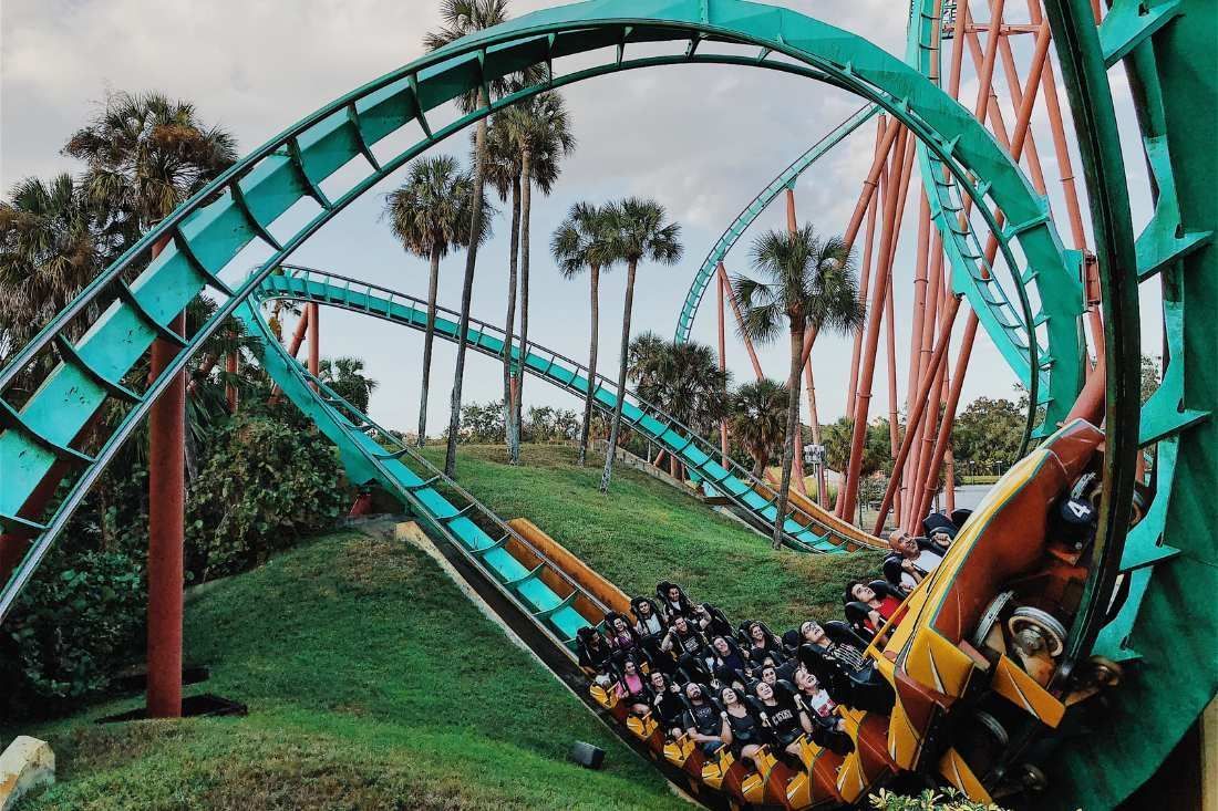 A Roller Coaster at an Amusement Park With People Riding It — MoneySmith Group In Kingscliff, NSW