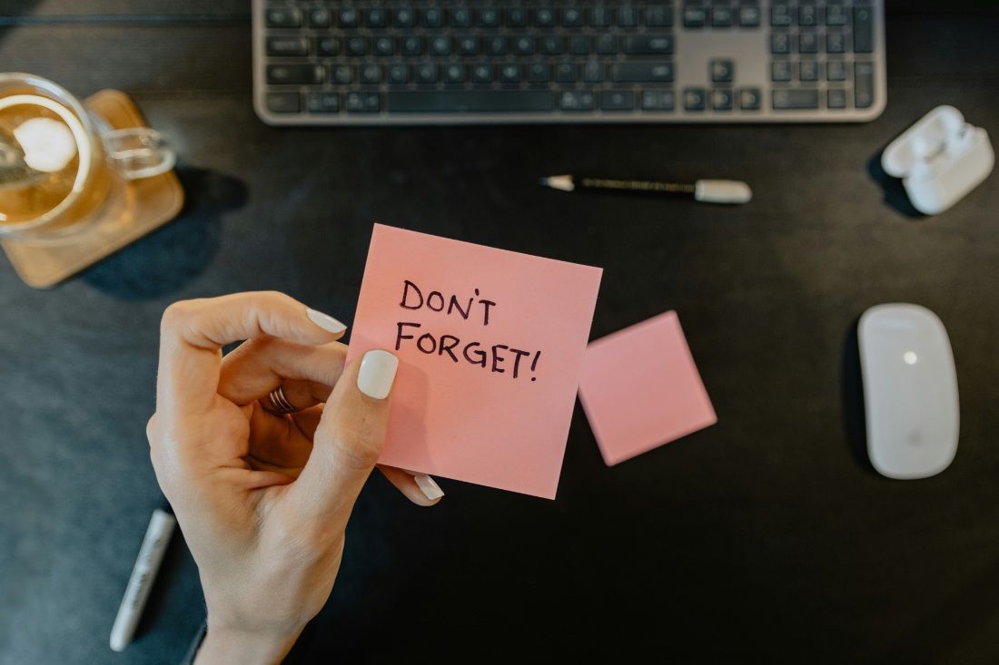 A Person is Holding a Pink Sticky Note That Says — MoneySmith Group In Kingscliff, NSW