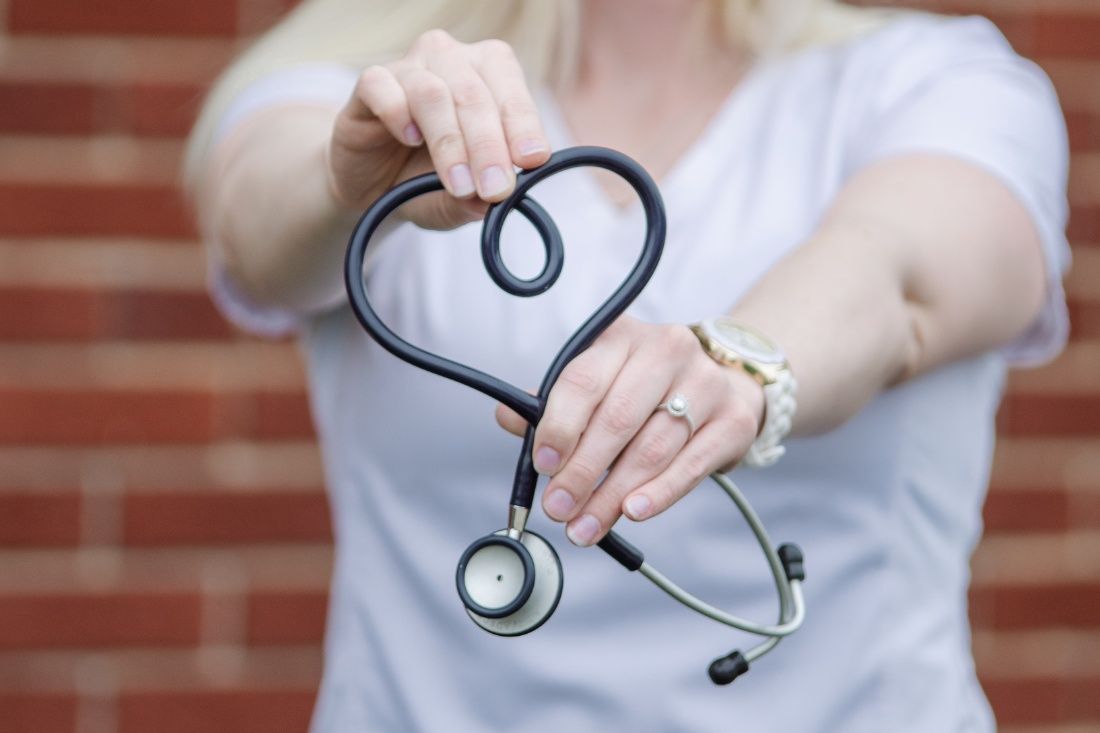 A Woman is Holding a Stethoscope in the Shape of a Heart — MoneySmith Group In Kingscliff, NSW