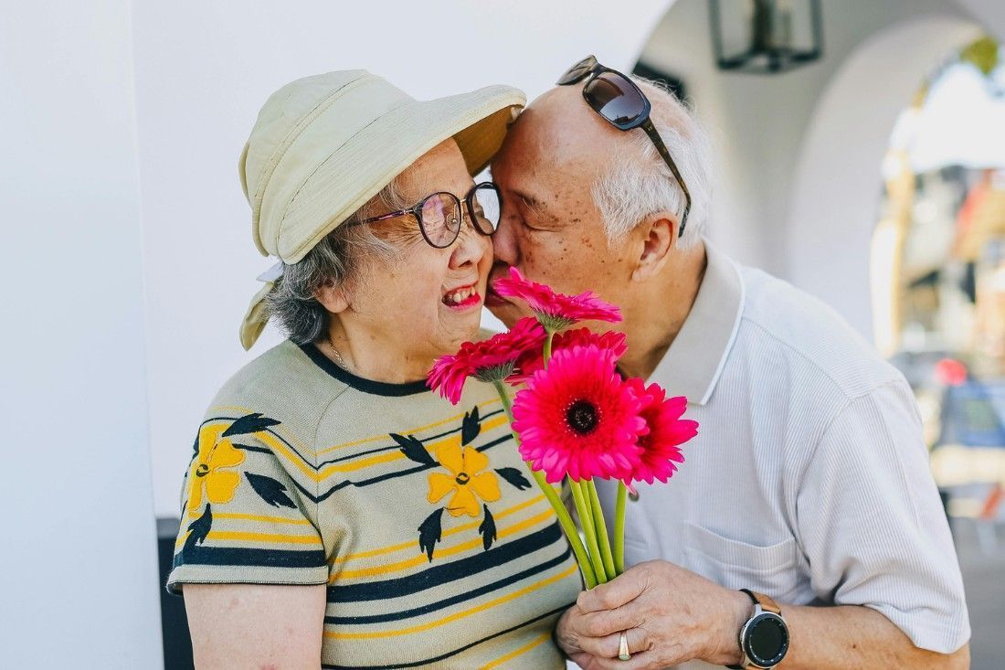 A Man is Kissing a Woman on the Forehead — MoneySmith Group In Kingscliff, NSW