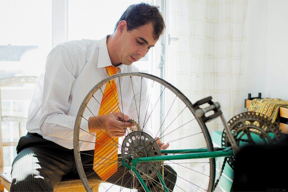 A Man In A Tie Is Fixing A Bicycle Wheel — MoneySmith Group In Kingscliff, NSW