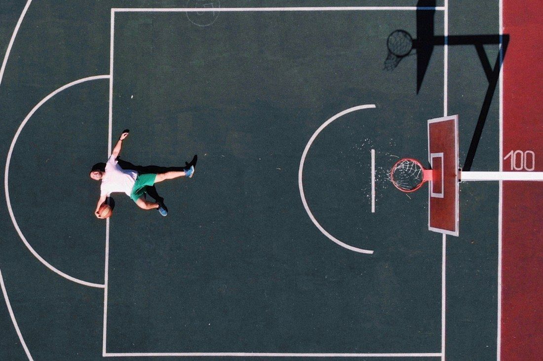 A Man is Doing a Handstand on a Basketball Court — MoneySmith Group In Kingscliff, NSW