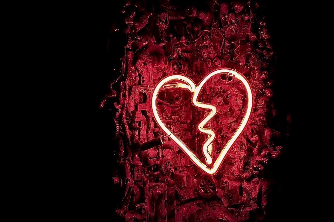 A Neon Sign of a Broken Heart on a Red Background — MoneySmith Group In Kingscliff, NSW