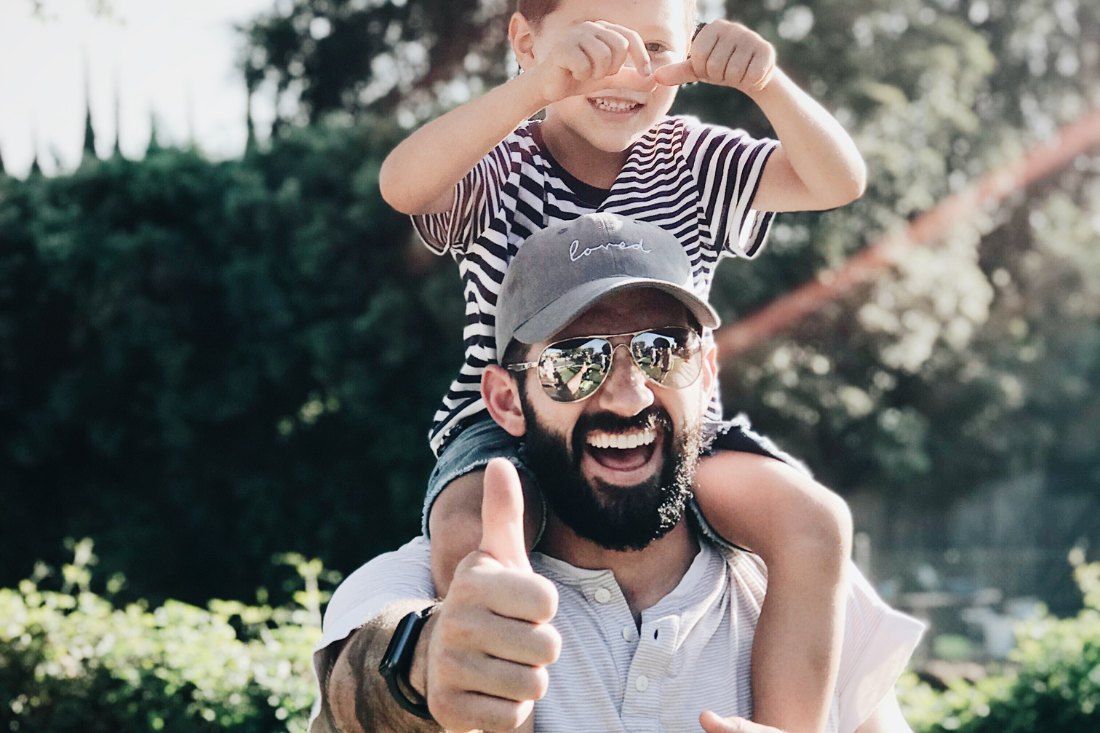 A Man is Carrying a Child on His Shoulders — MoneySmith Group In Kingscliff, NSW