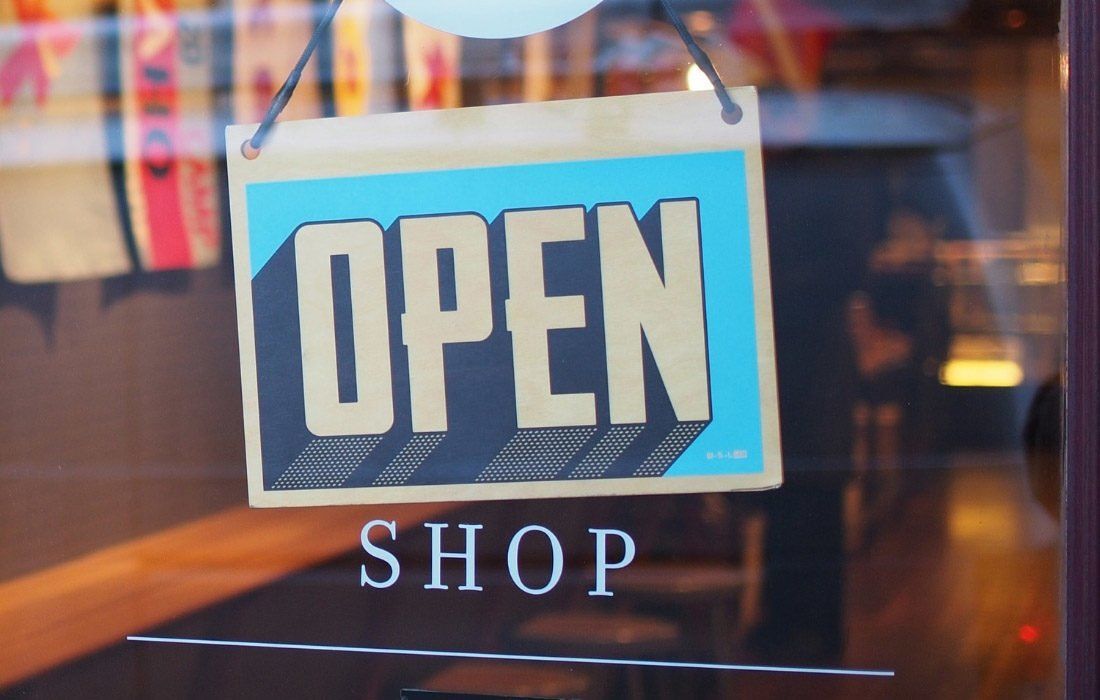 An Open Shop Sign Hangs in a Store — MoneySmith Group In Kingscliff, NSW