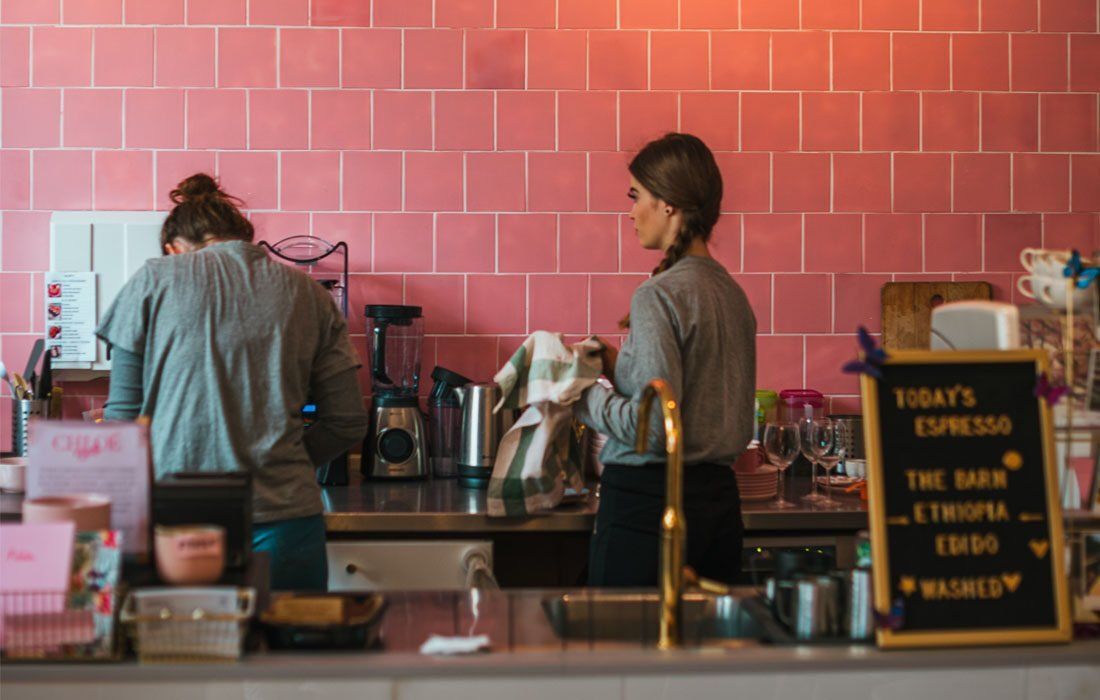 Two Women Are Working in a Kitchen — MoneySmith Group In Kingscliff, NSW