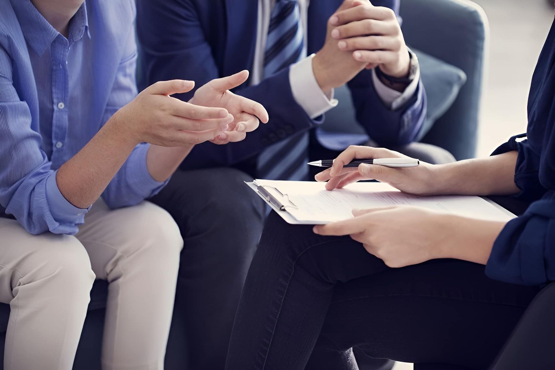 A Group of People Are Sitting Around a Table Talking to Each Other — MoneySmith Group In Murwillumbah, NSW