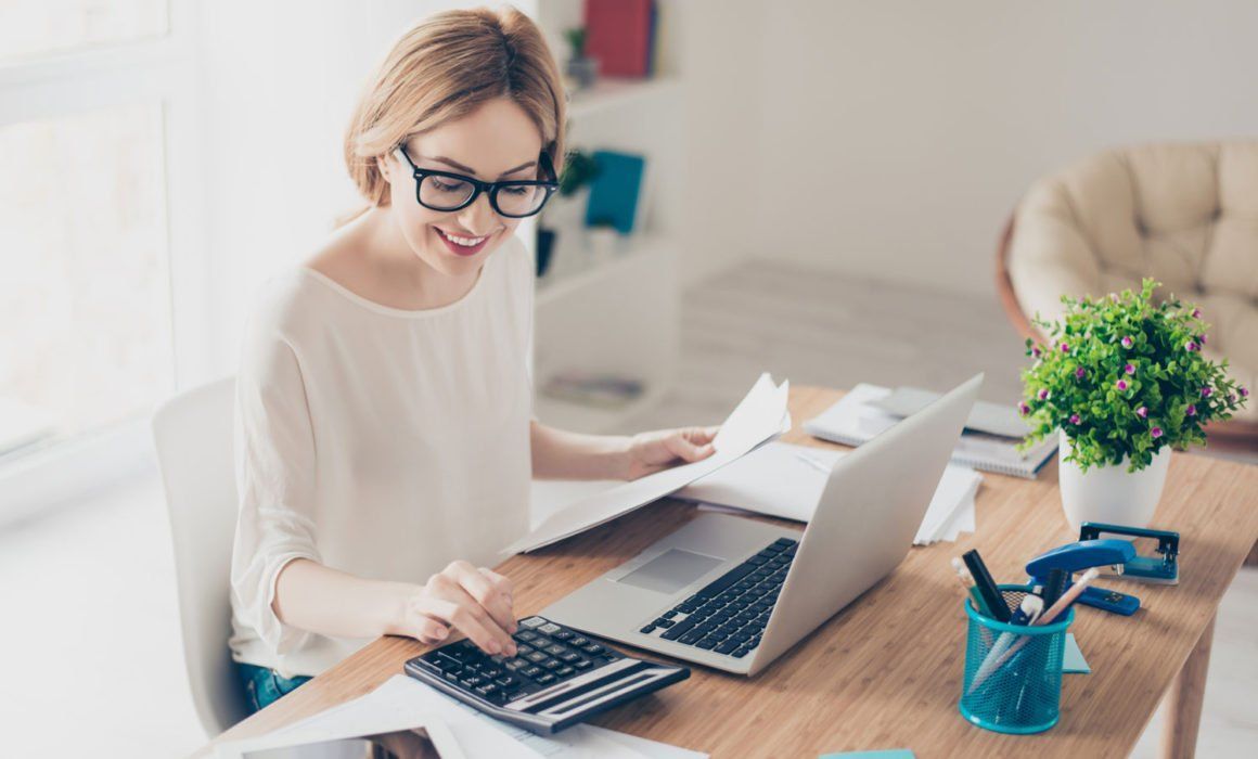 A Woman is Sitting at a Desk — MoneySmith Group In Kingscliff, NSW