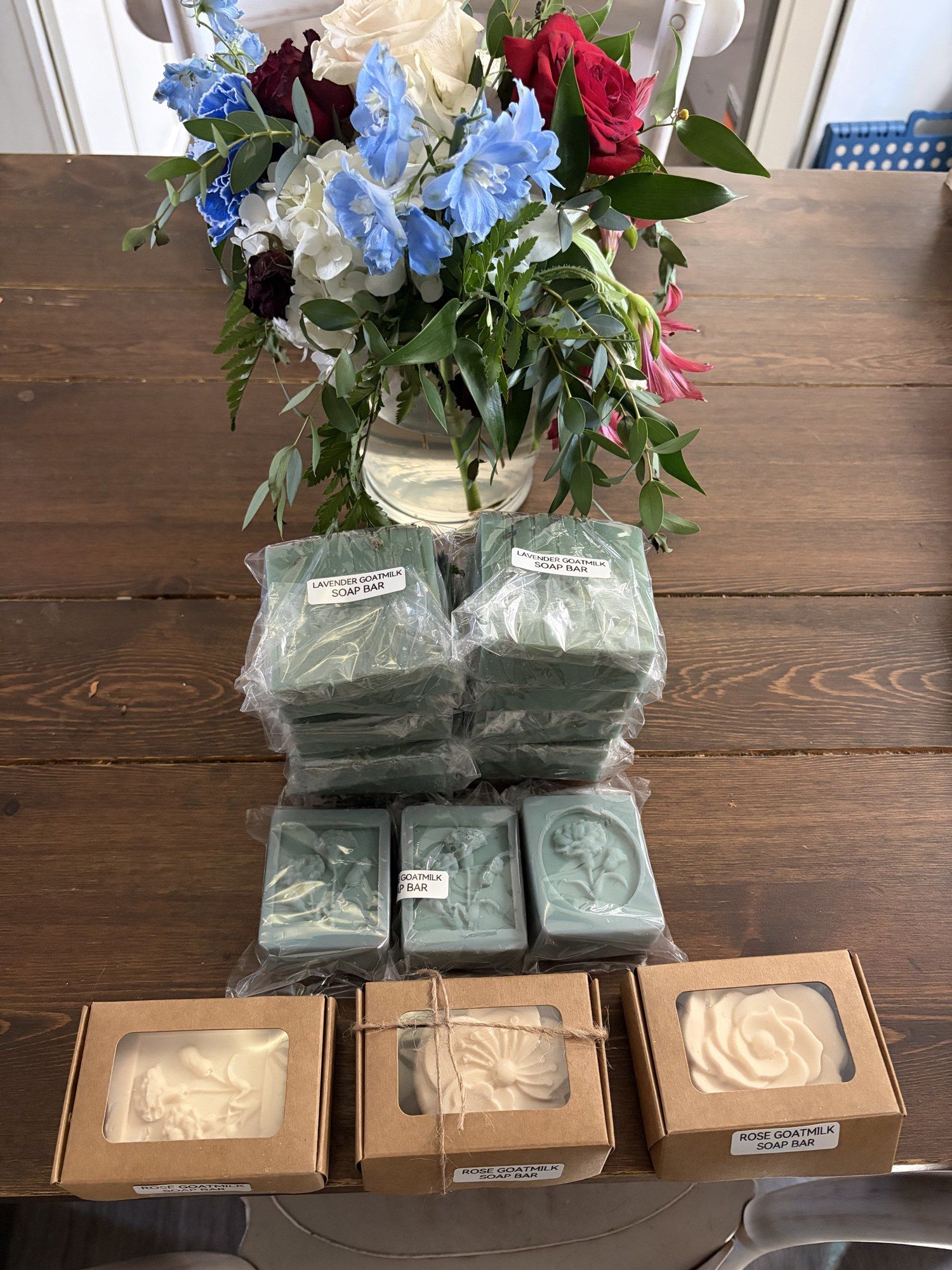 Handmade soap bars and boxed soaps arranged on our table