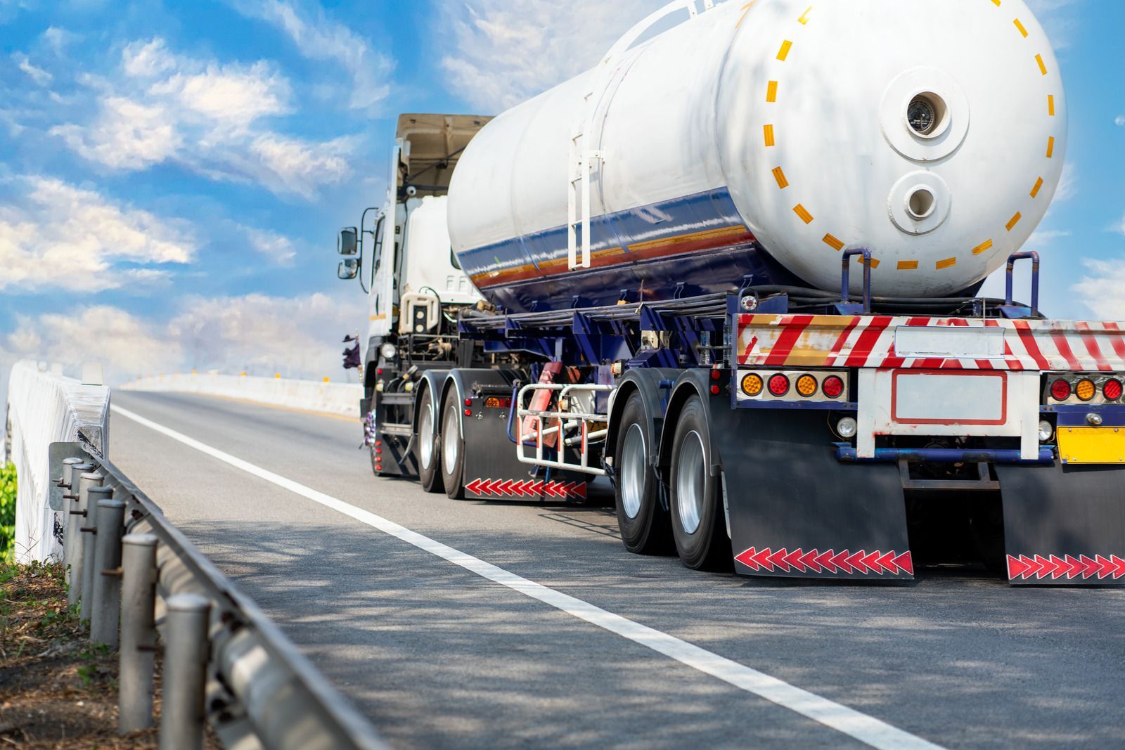 A tanker truck is driving down a highway.