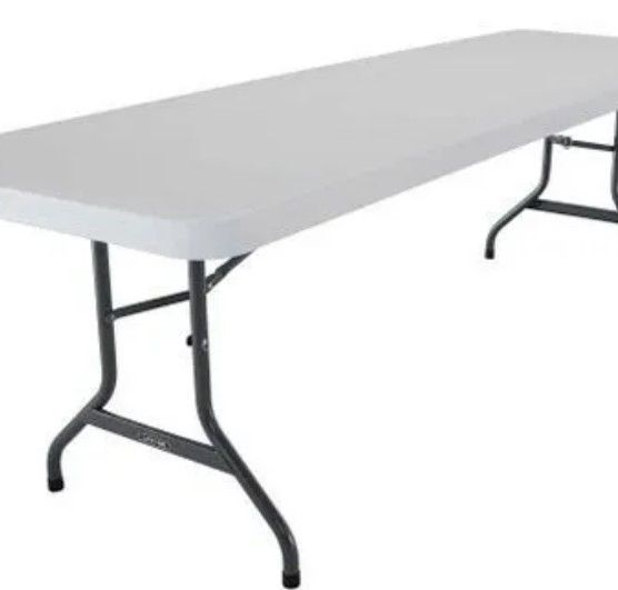 A white folding table with black legs on a white background.