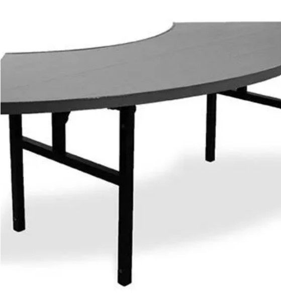 A curved table with black legs on a white background.