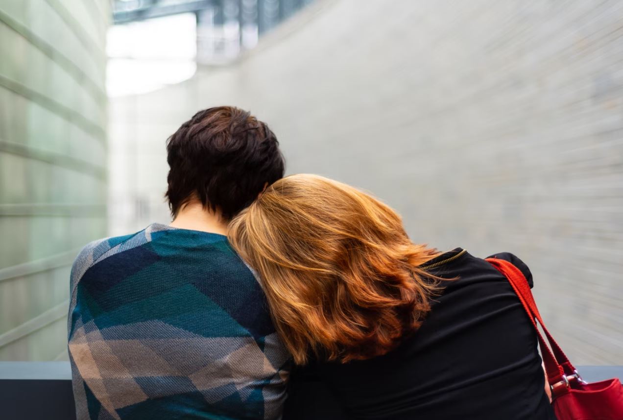 man comforting woman