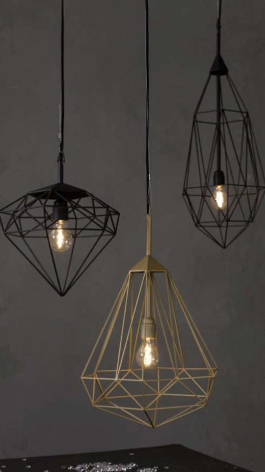 Three pendant lights in the shape of a diamond are hanging from the ceiling.
