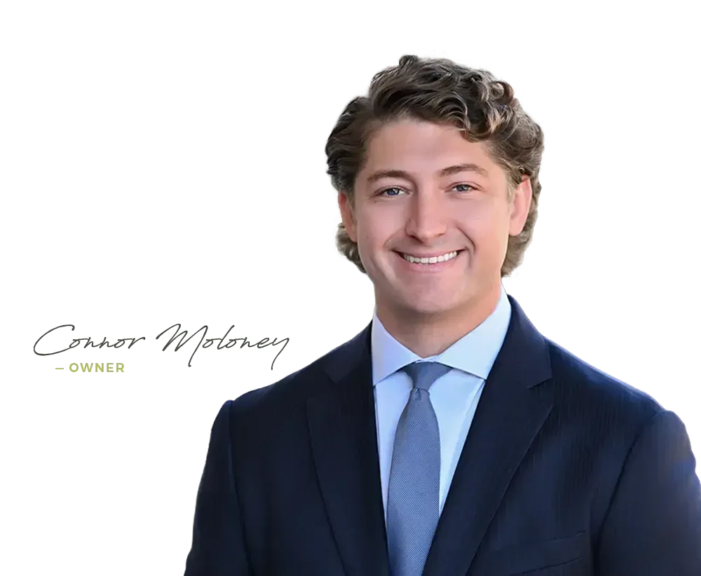 Portrait of a smiling man in a navy suit and blue tie with signature text on a white background
