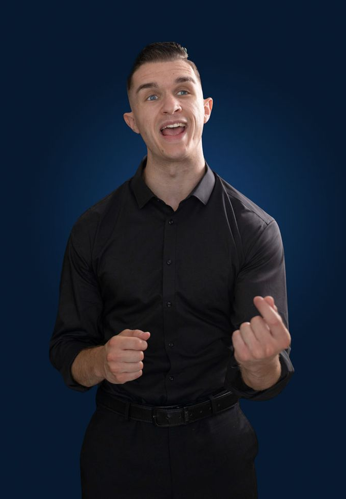 Man in black shirt speaking and gesturing against a dark blue background