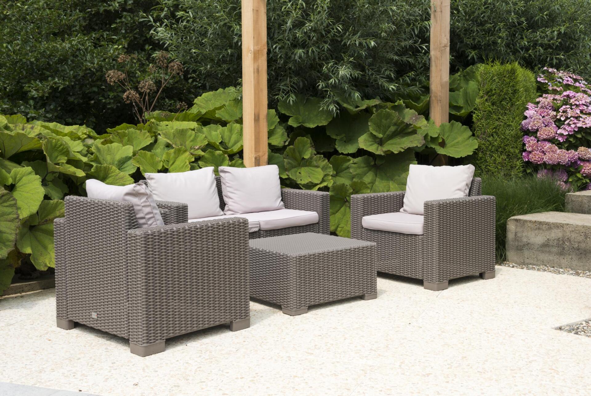 a concrete patio with chairs and table
