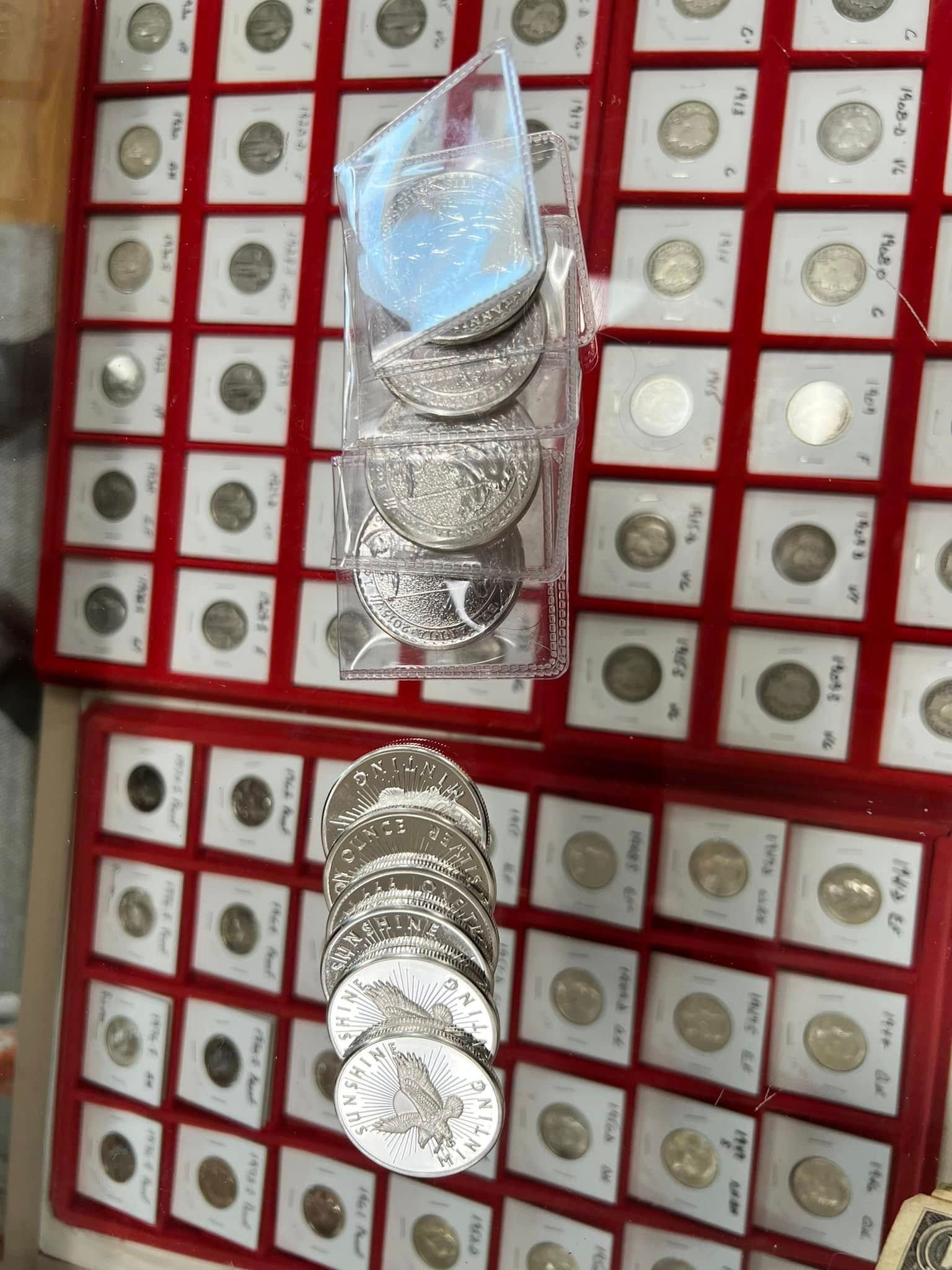 Stacks of silver coins in plastic bags displayed on a red-and-white wall rack