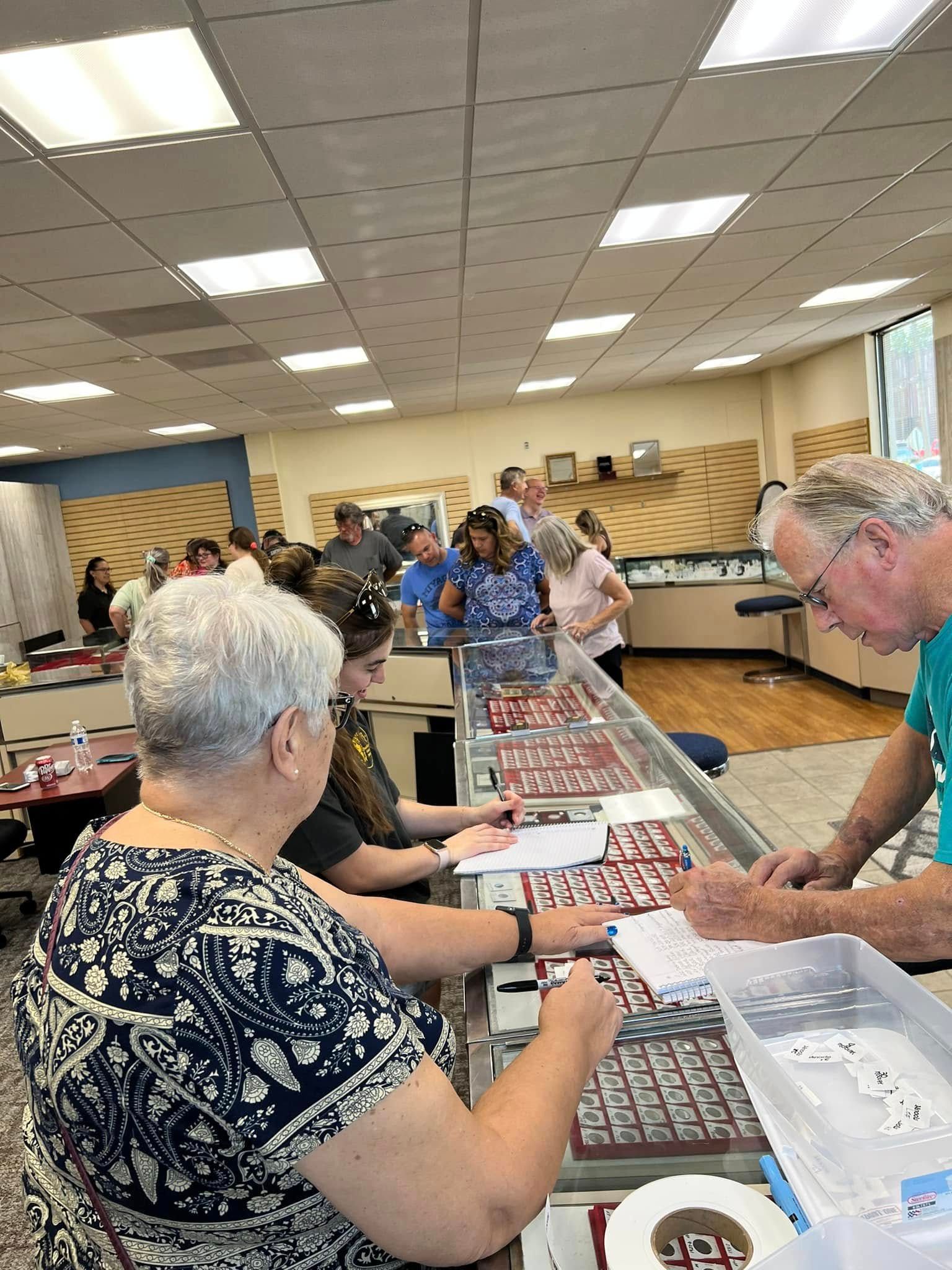 People seated at tables playing bingo in a bright community hall.