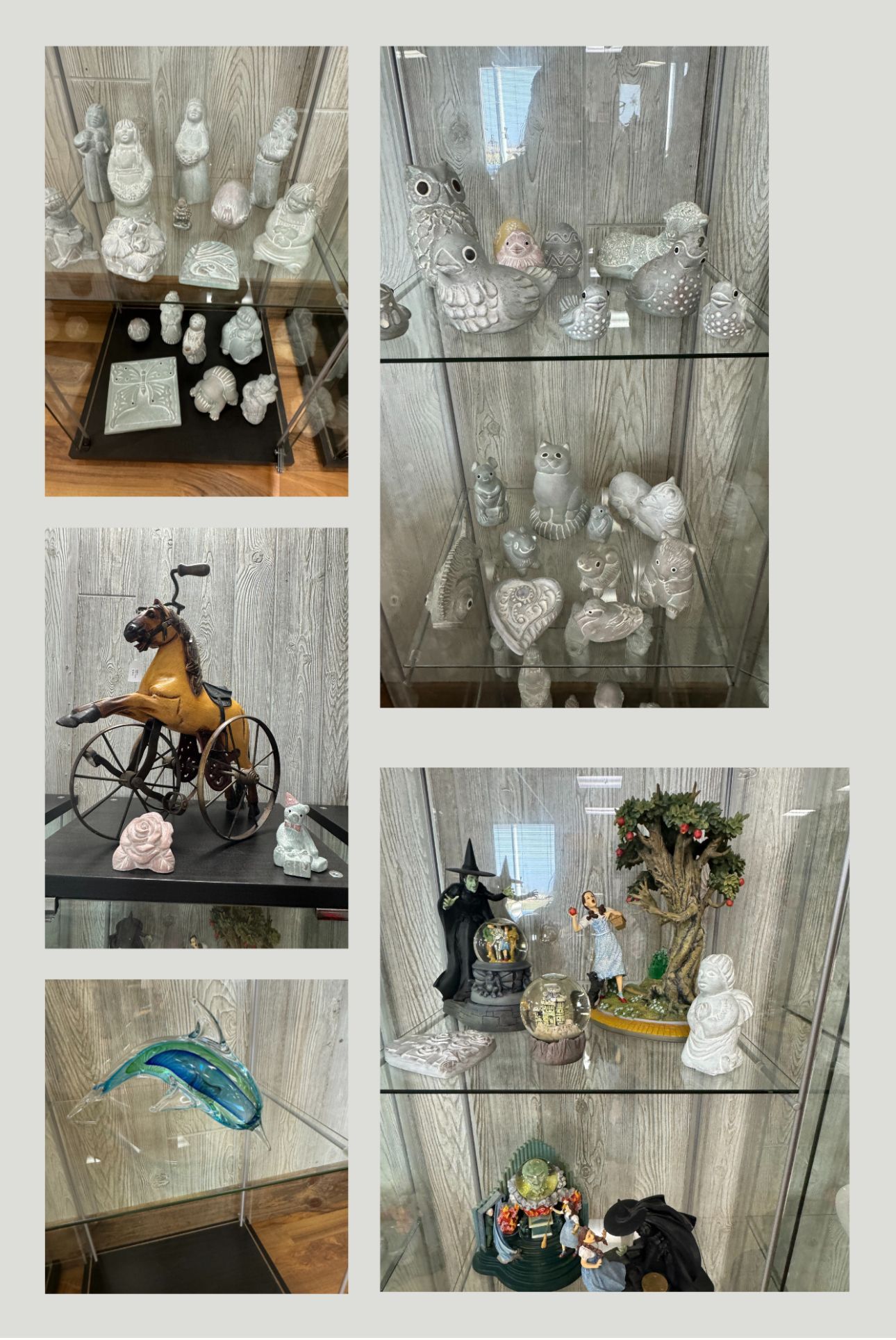 Glass shelf displays with crystal decor, a bicycle figurine, blue fish sculpture, and small decorative arrangements.