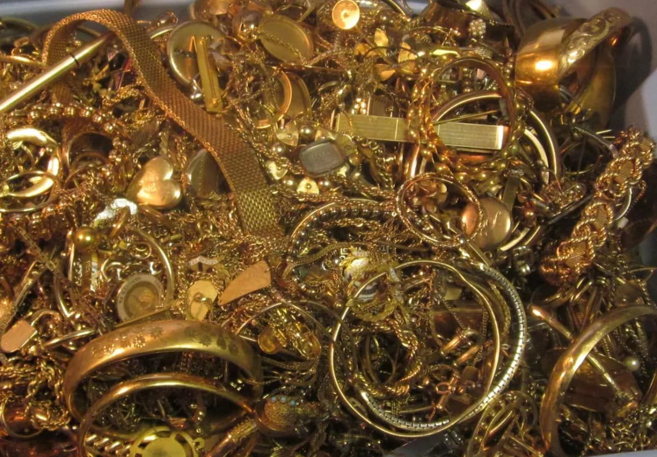 Pile of assorted gold jewelry and rings scattered together