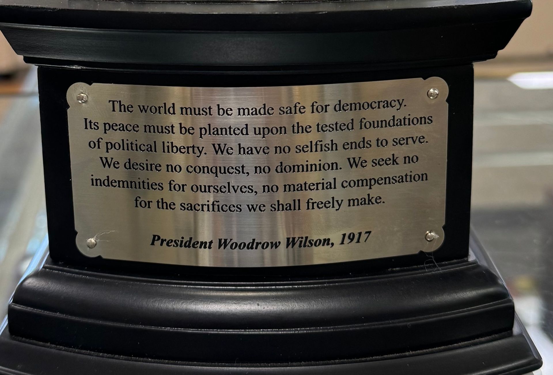 Plaque on a pedestal with a quote from President Woodrow Wilson about democracy and national defense.