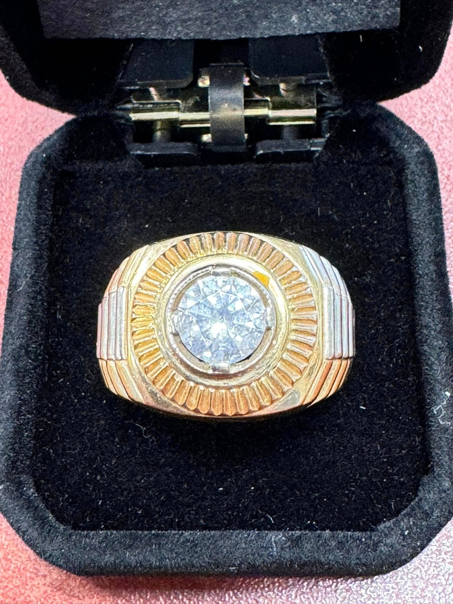 Gold and silver diamond ring in a black velvet box