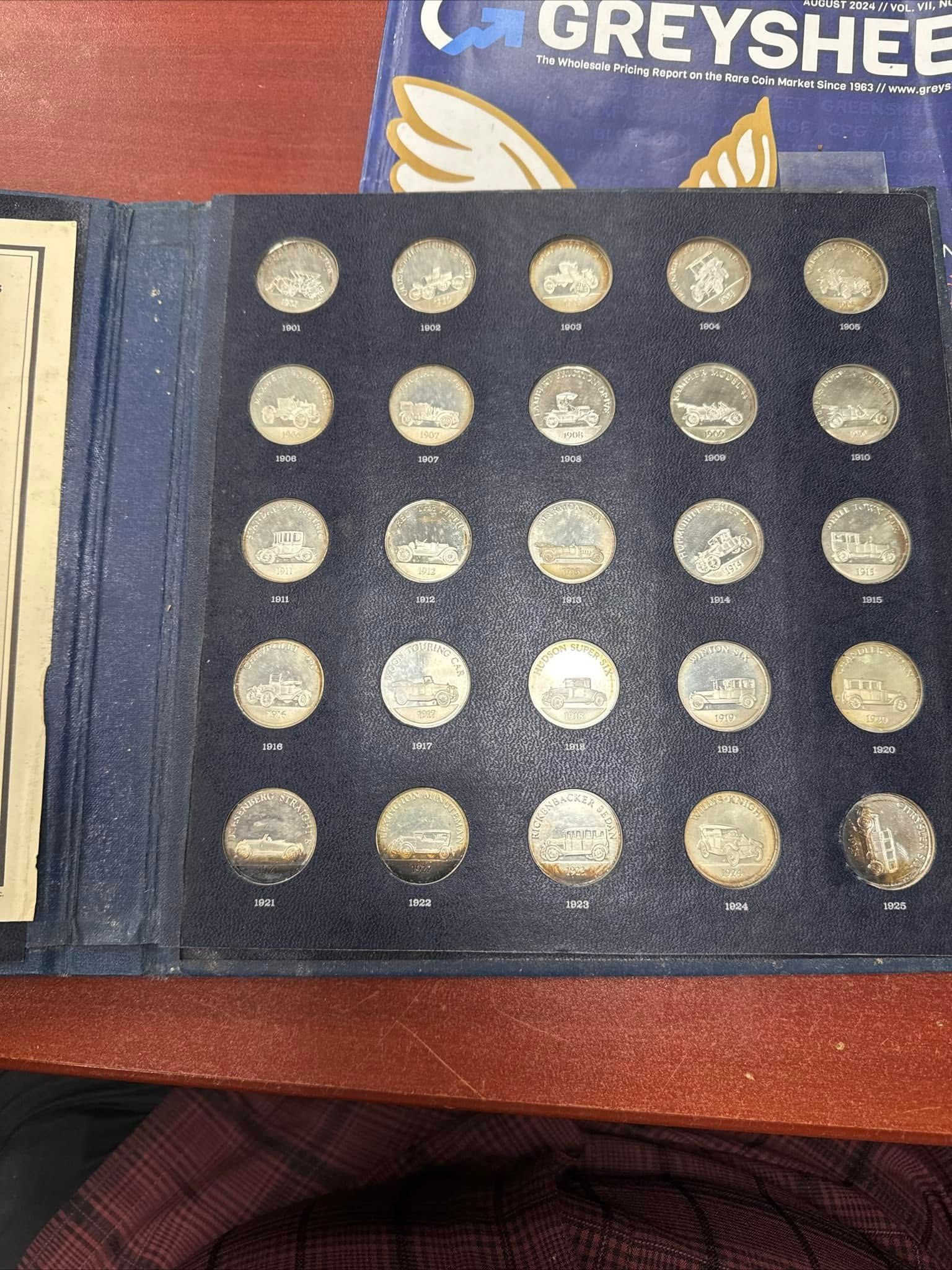 Close-up of a blue case with rows of gold coins on a wooden surface