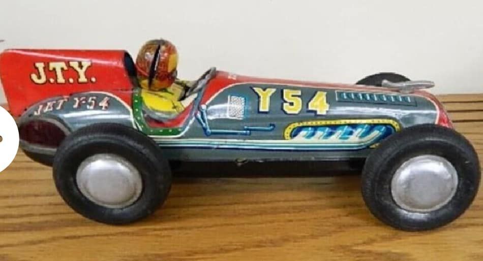 Toy racing car with red, blue, and black body, marked Y54, on a wooden surface
