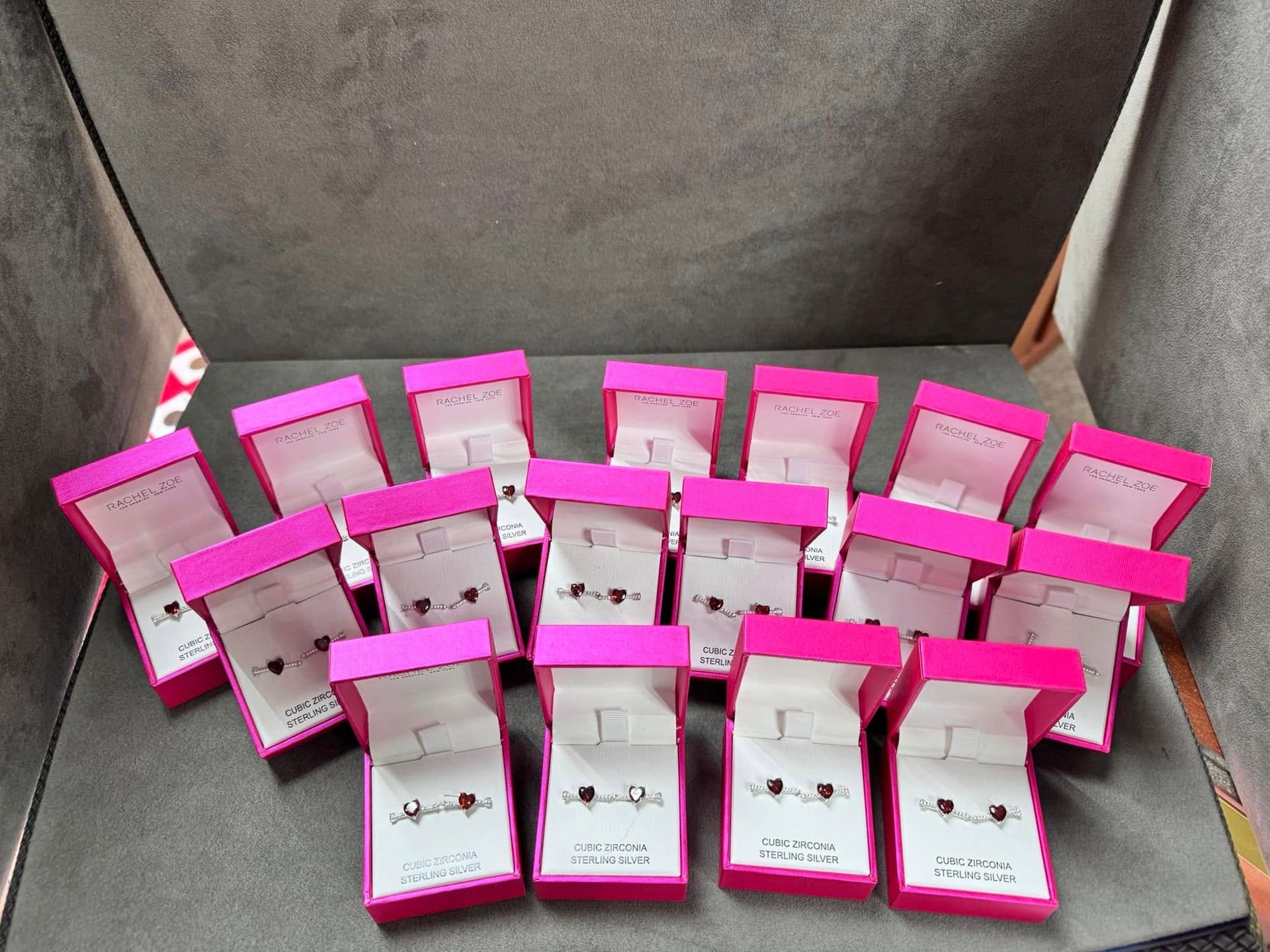 Pink and white snack pouches arranged in rows inside a gray container