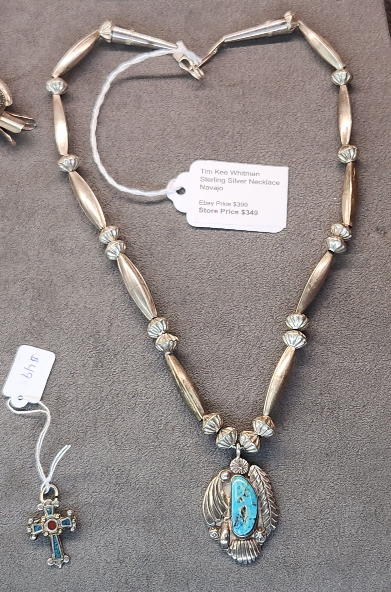 Heart-shaped necklace with turquoise pendant and matching earrings on a gray background