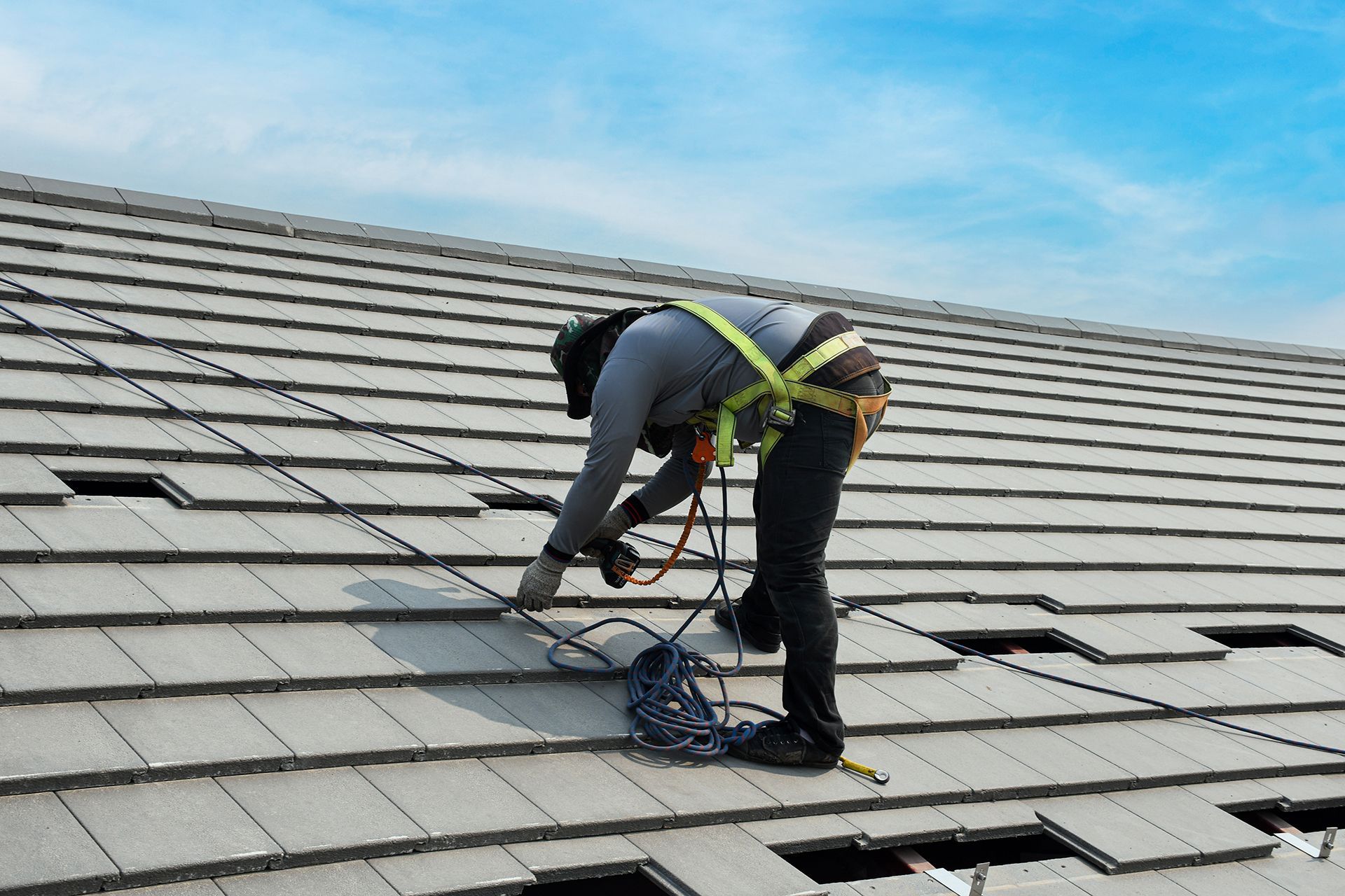 A man is working on the roof of a building.