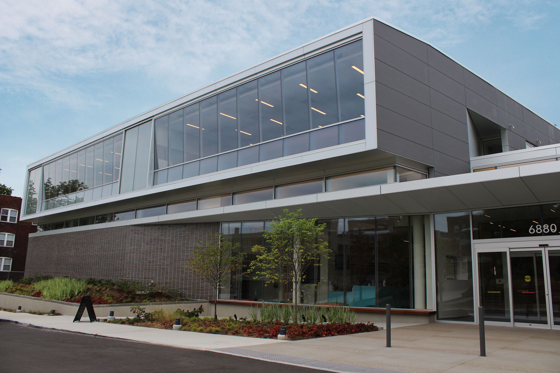 Modern library building with large windows and a covered entrance.