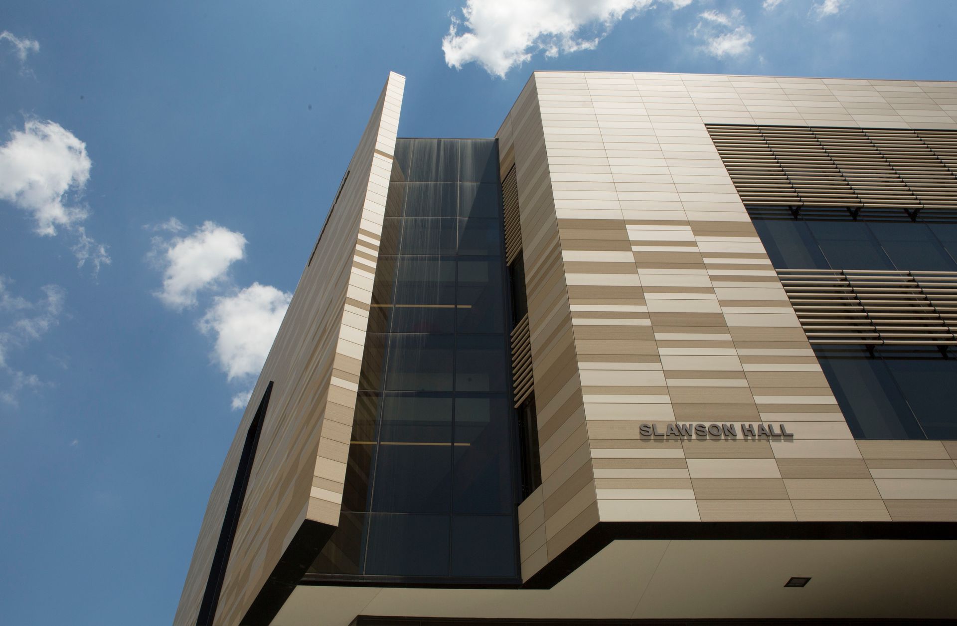 Modern building, Lawson Hall, with stone facade and glass windows against a blue sky.