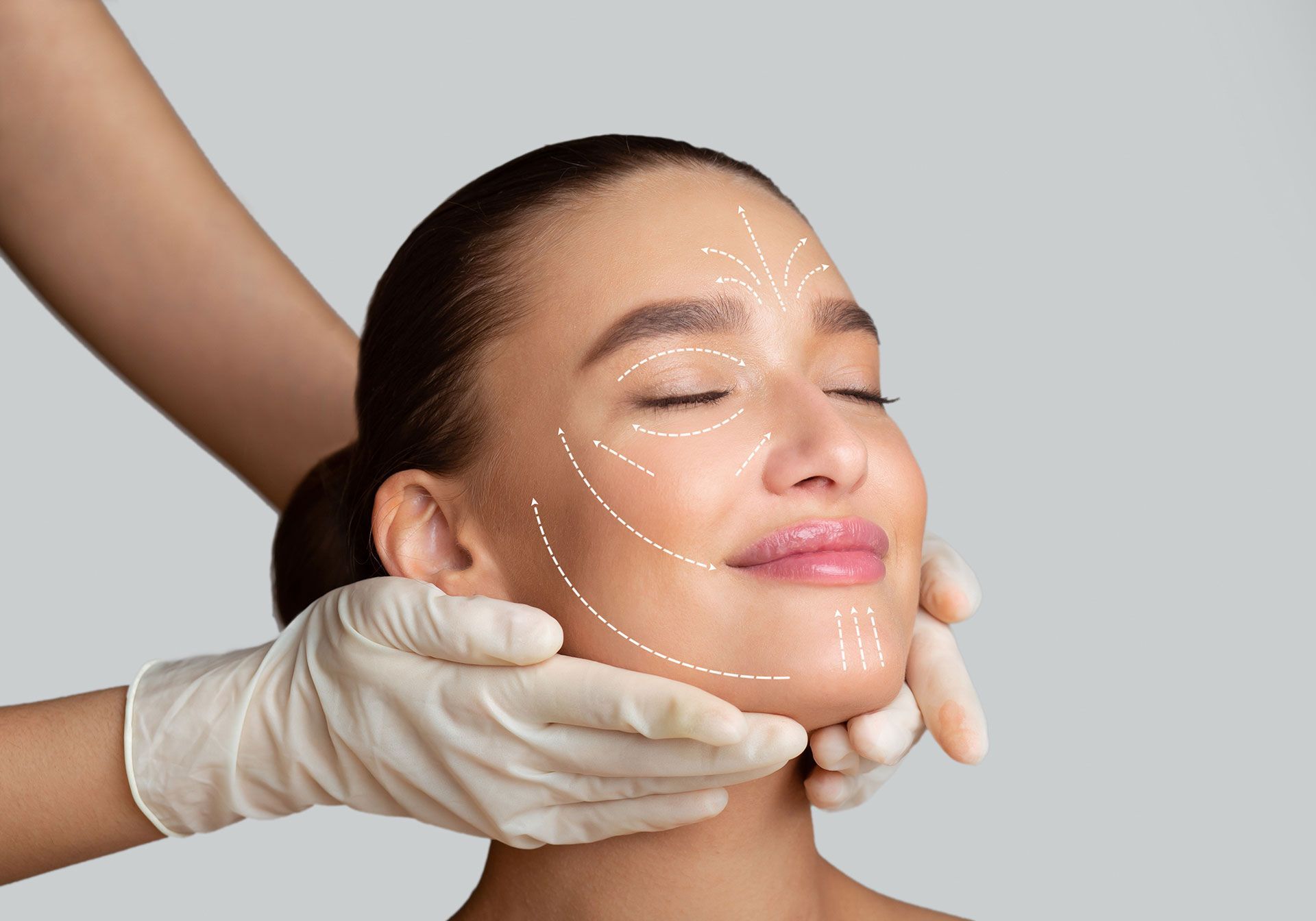 Calm girl receiving face massage from cosmetologist