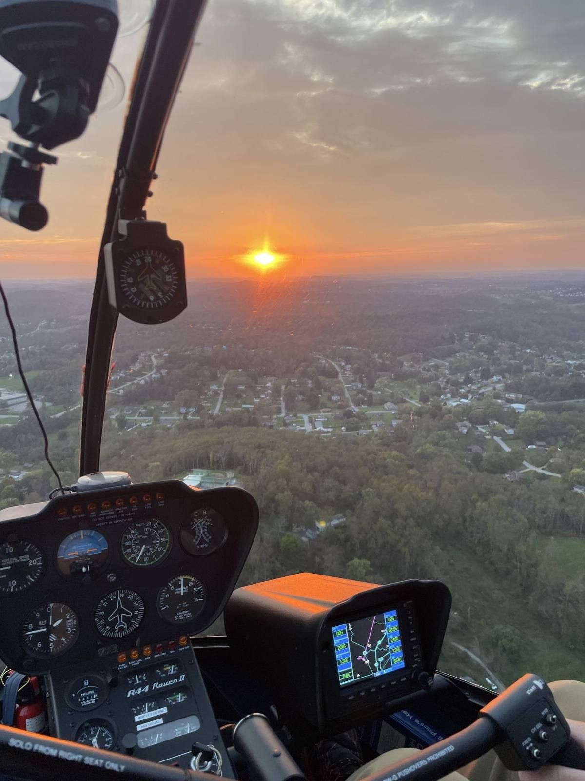 Cockpit sunset flight in an R44
