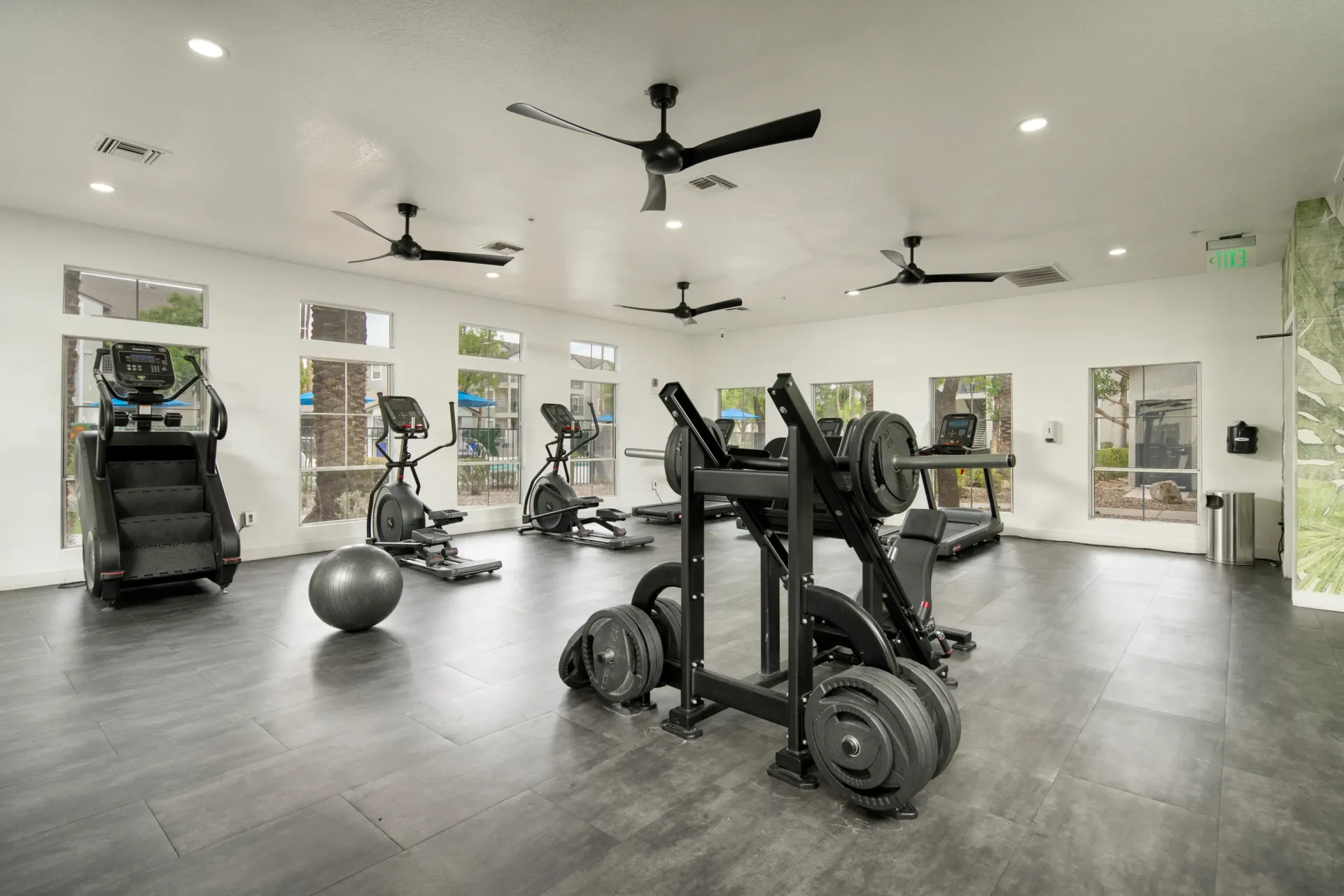 Fitness center with cardio machines, weightlifting equipment, and a stability ball at Heritage at Deer Valley in Phoenix, AZ.