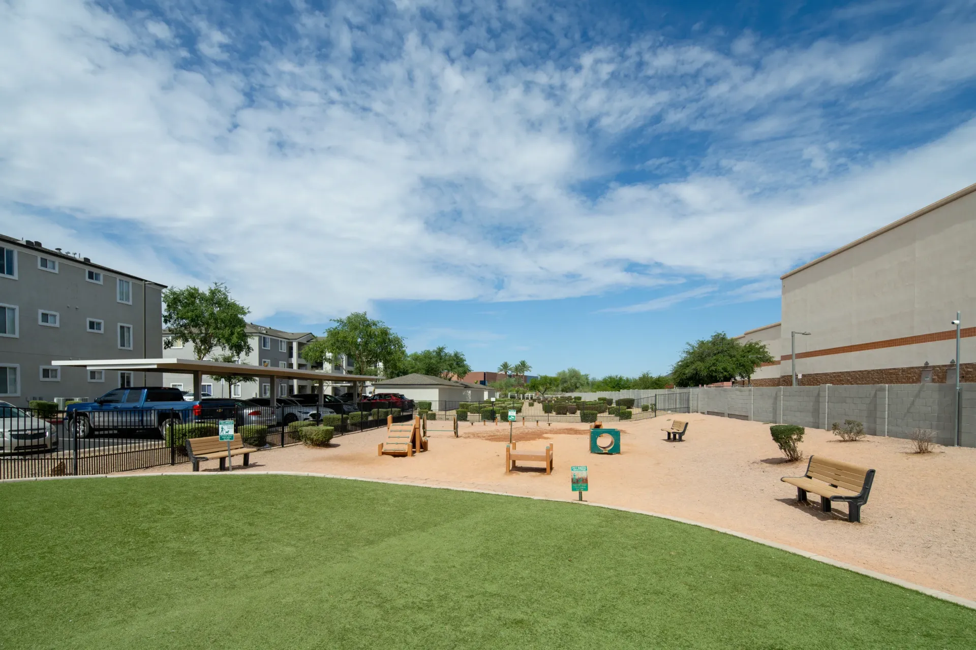 Dog park area with agility equipment and benches at Heritage at Deer Valley in Phoenix, AZ.