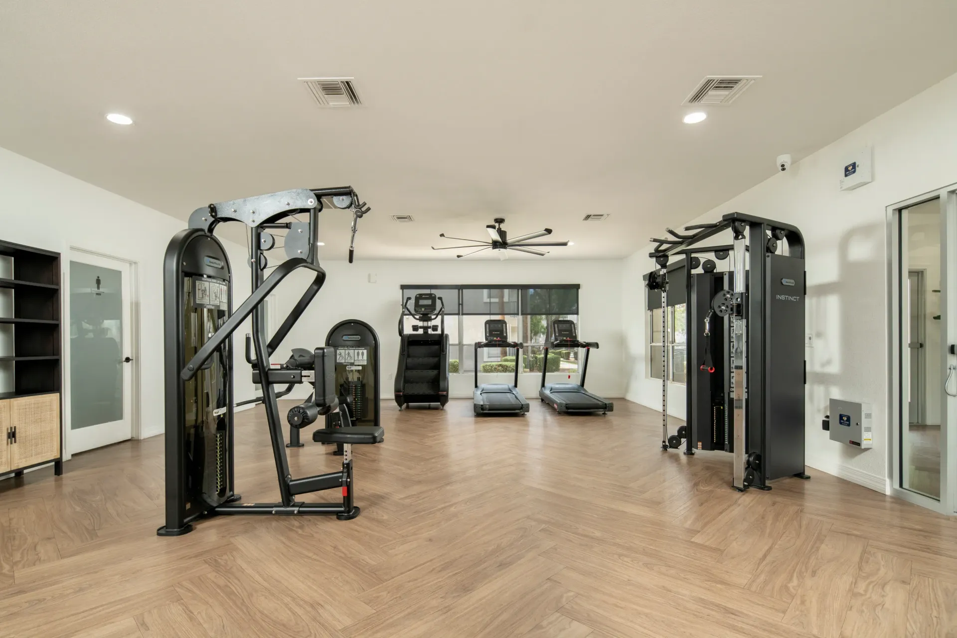 Interior view of a well-equipped apartment complex gym with treadmills and weight machines at Heritage at Deer Valley in Phoenix, AZ.