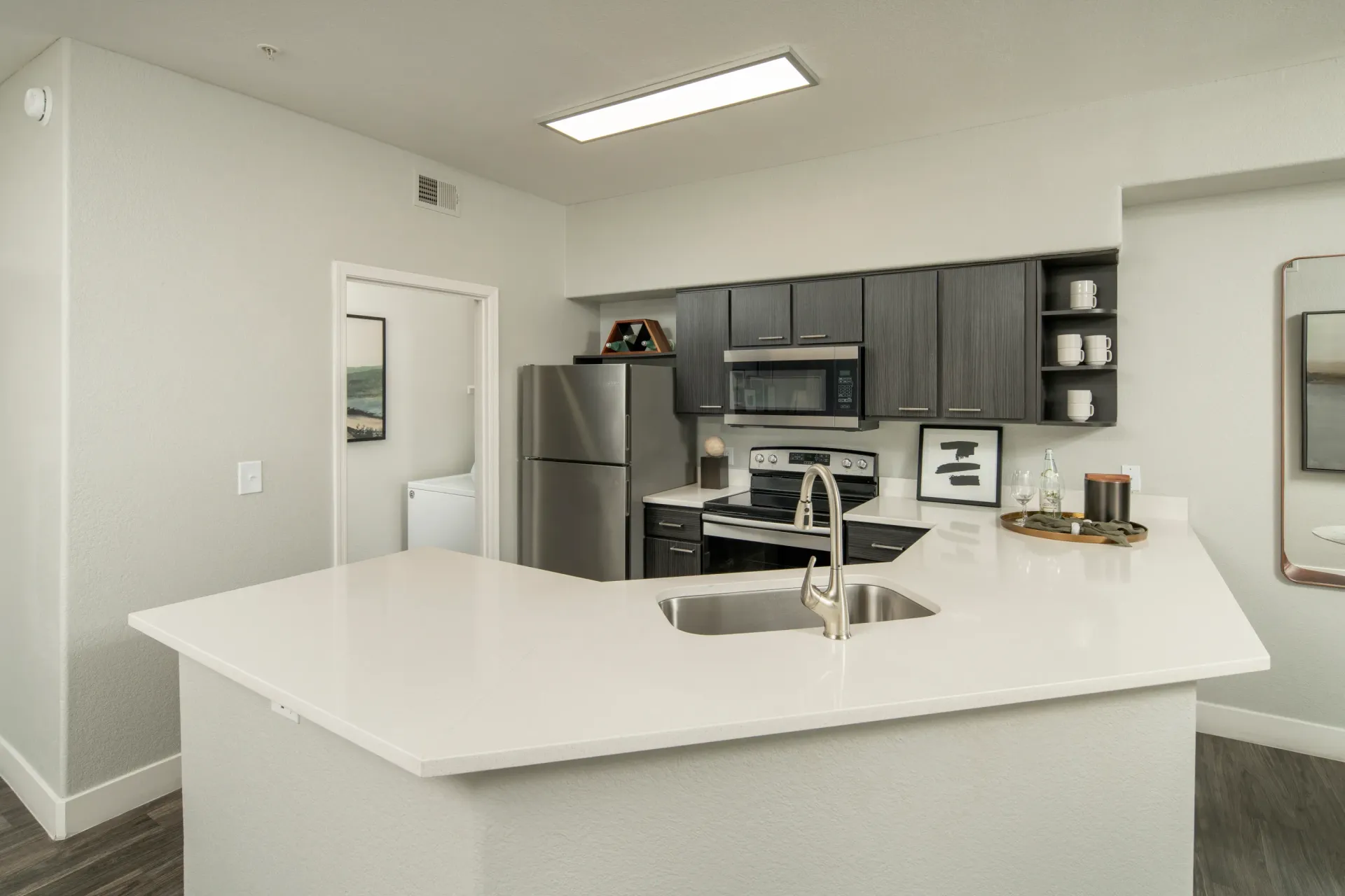 Modern kitchen with stainless steel appliances, granite countertops, and a large island at Heritage at Deer Valley in Phoenix, AZ.