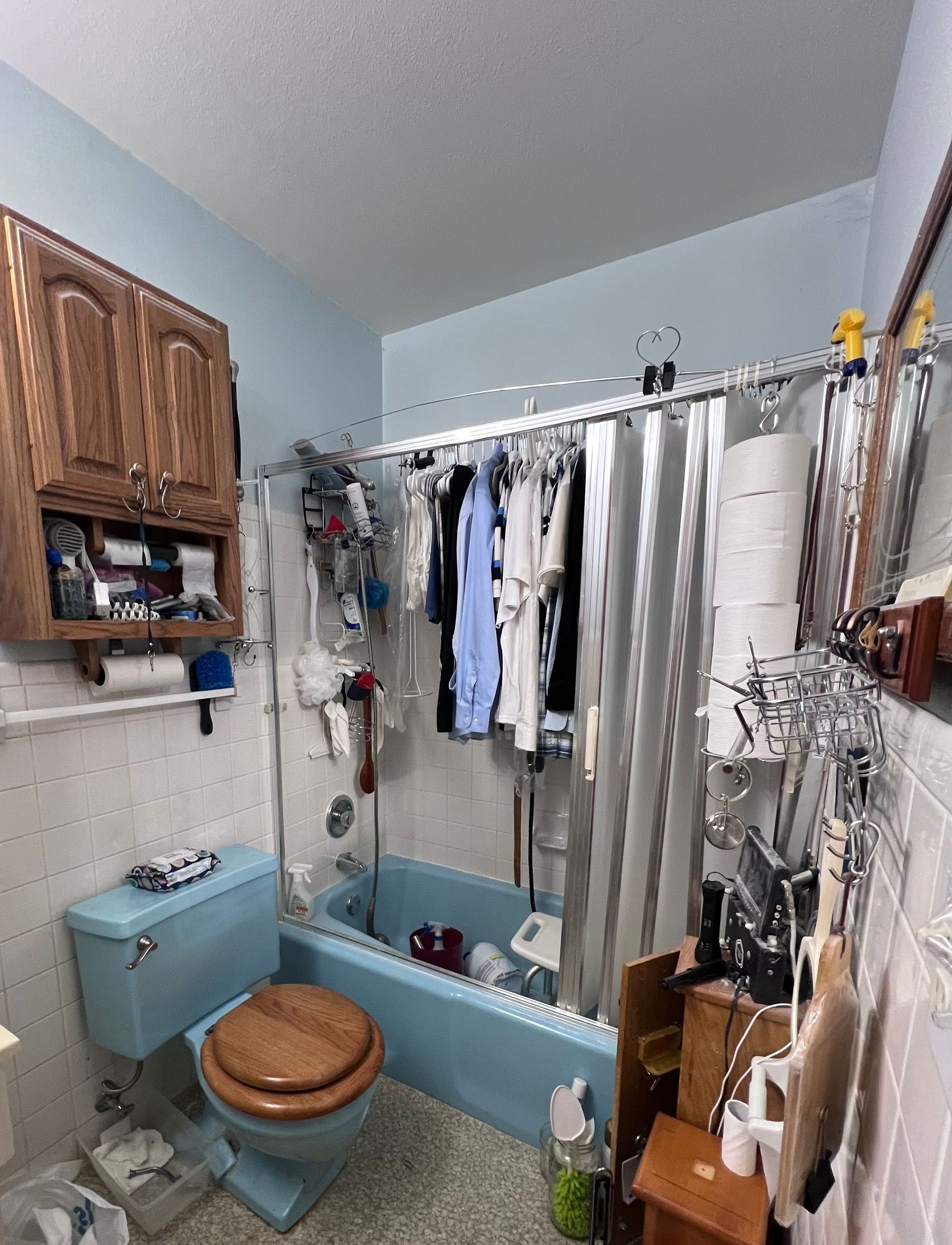 A bathroom with a toilet , bathtub and shower curtain.